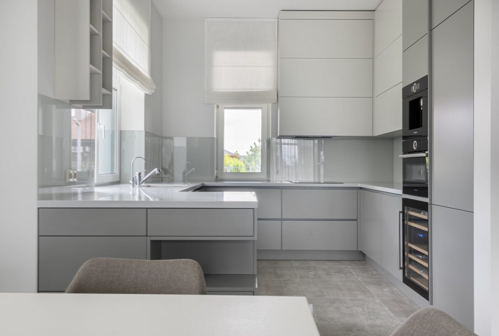 modern kitchen with white cupboards and table. Showing how to ADHD Hack your Home Decor!